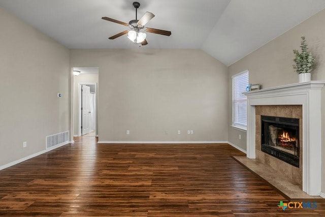 1117 Branchwood Way, Temple, TX 76502 - unfurnished living room featuring a ceiling fan, dark wood finished floors, a tile fireplace, and vaulted ceiling