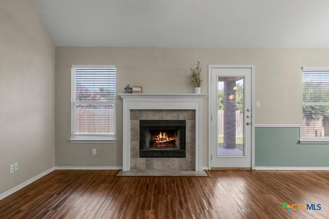 1117 Branchwood Way, Temple, TX 76502 - unfurnished living room featuring a tile fireplace, wood finished floors, and healthy amount of natural light