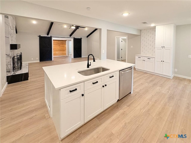 4310 Antelope Trl, Temple, TX 76504 - kitchen featuring dishwasher, a barn door, open floor plan, white cabinetry, and a center island with sink