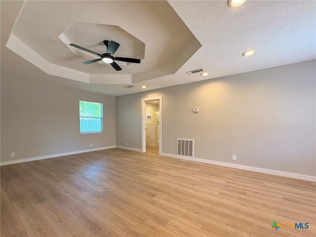 4310 Antelope Trl, Temple, TX 76504 - unfurnished room with a raised ceiling, a ceiling fan, light wood-type flooring, a textured ceiling, and recessed lighting