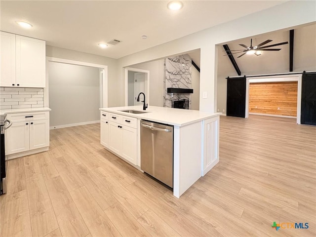 4310 Antelope Trl, Temple, TX 76504 - kitchen featuring dishwasher, open floor plan, light wood-style floors, white cabinets, and vaulted ceiling
