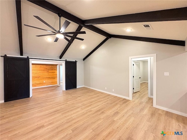 4310 Antelope Trl, Temple, TX 76504 - unfurnished living room featuring a barn door, ceiling fan, and light wood-type flooring