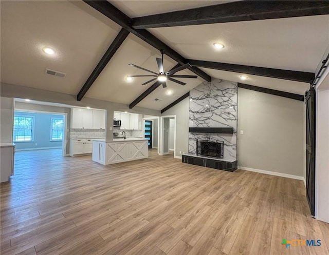 4310 Antelope Trl, Temple, TX 76504 - unfurnished living room featuring ceiling fan, light wood-style floors, and a fireplace