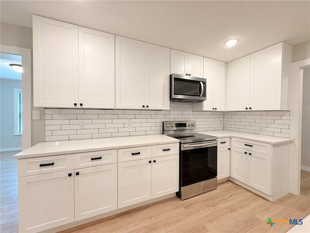 4310 Antelope Trl, Temple, TX 76504 - kitchen with stainless steel appliances, light wood-type flooring, light countertops, white cabinets, and recessed lighting