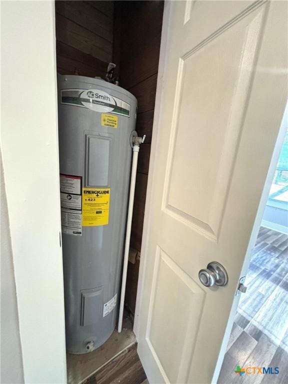 utility room featuring electric water heater