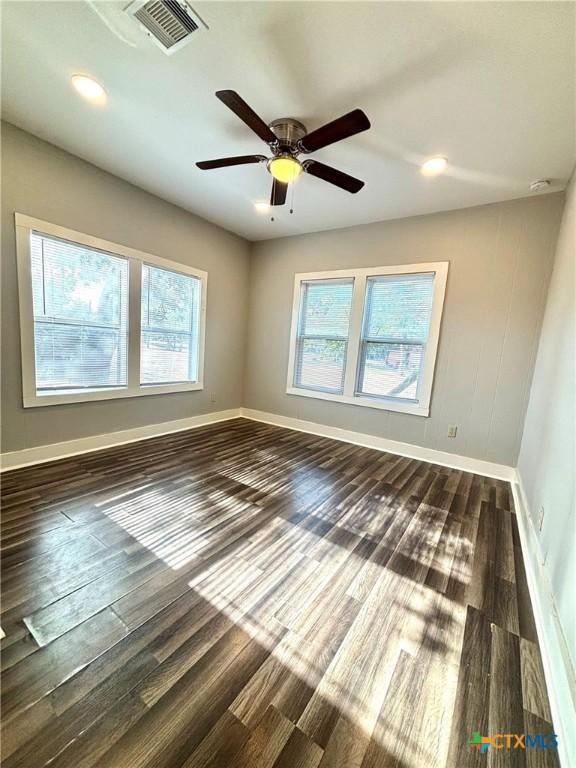 unfurnished room featuring ceiling fan and dark hardwood / wood-style floors