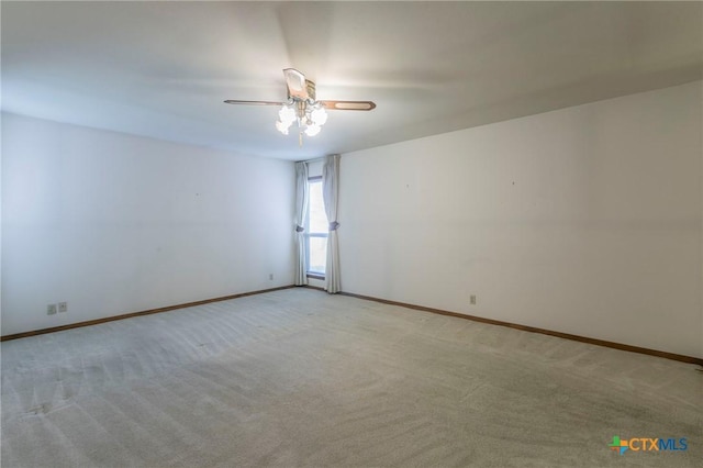 empty room with light colored carpet and baseboards