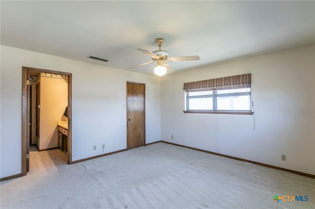 unfurnished bedroom featuring visible vents, ceiling fan, light carpet, and baseboards