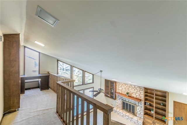 hallway with carpet flooring and vaulted ceiling