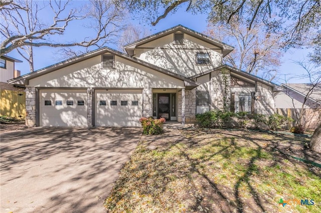 view of front of home featuring stone siding, concrete driveway, and an attached garage