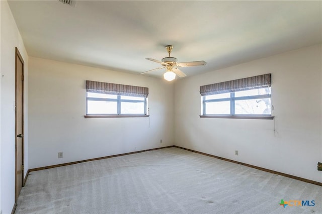 unfurnished room with carpet floors, ceiling fan, and baseboards