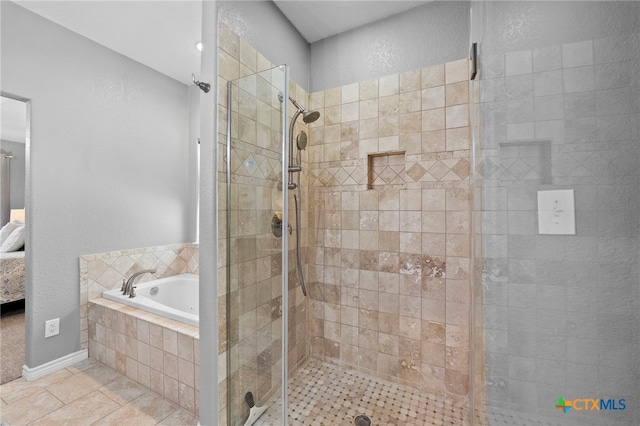 721 Gallagher Dr, Canyon Lake, TX 78133 - bathroom with a bath, a stall shower, ensuite bathroom, tile patterned flooring, and a textured wall