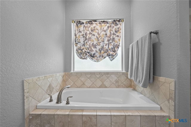 721 Gallagher Dr, Canyon Lake, TX 78133 - full bathroom with a textured wall and a garden tub