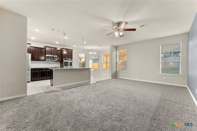 unfurnished living room featuring light carpet and ceiling fan with notable chandelier