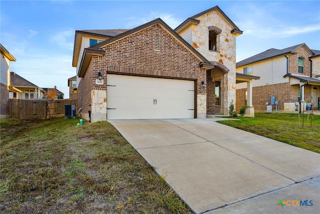 view of front of property with a garage, central air condition unit, and a front yard