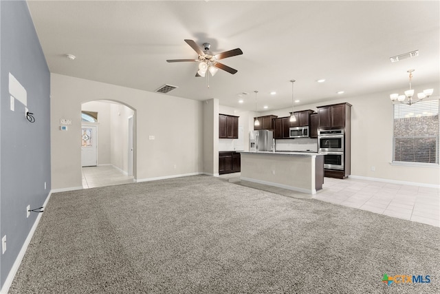 unfurnished living room with ceiling fan with notable chandelier and light colored carpet