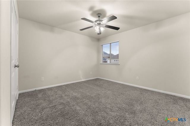 carpeted spare room with ceiling fan