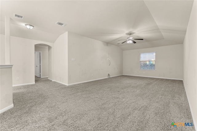 empty room with carpet flooring, ceiling fan, and vaulted ceiling