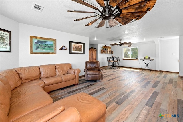 463 County Road 436, Thorndale, TX 76577 - living room with a ceiling fan, wood finished floors, a textured ceiling, and baseboards