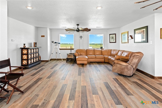 living room with hardwood / wood-style floors and a textured ceiling