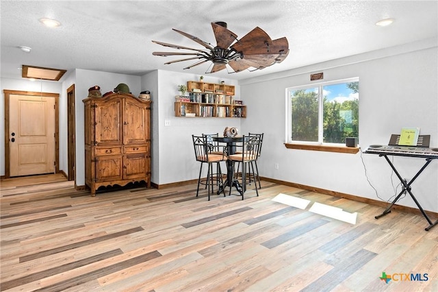 463 County Road 436, Thorndale, TX 76577 - dining area with light wood finished floors, baseboards, a textured ceiling, a ceiling fan, and recessed lighting
