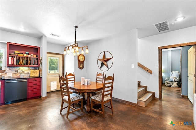 dining room featuring a notable chandelier and a textured ceiling