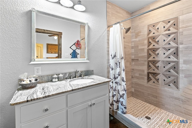 bathroom with a shower with shower curtain and vanity