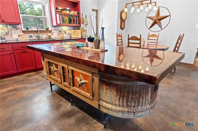 bar featuring tasteful backsplash and sink