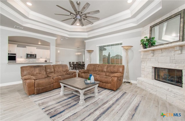 2109 Mercer St, Nolanville, TX 76559 - living area with a raised ceiling, crown molding, light wood finished floors, and visible vents