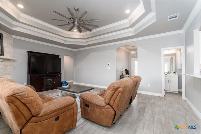 2109 Mercer St, Nolanville, TX 76559 - living room with a ceiling fan, visible vents, a raised ceiling, arched walkways, and ornamental molding