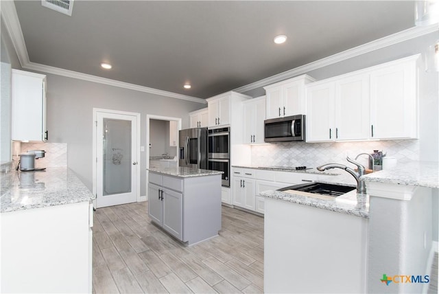 2109 Mercer St, Nolanville, TX 76559 - kitchen with a sink, stainless steel appliances, visible vents, white cabinetry, and decorative backsplash