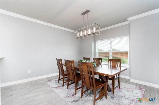 2109 Mercer St, Nolanville, TX 76559 - dining space featuring an inviting chandelier, ornamental molding, baseboards, and light wood-type flooring