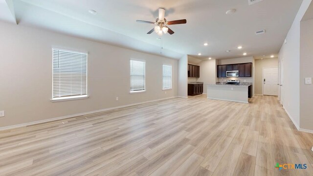 unfurnished living room with ceiling fan and light wood-type flooring