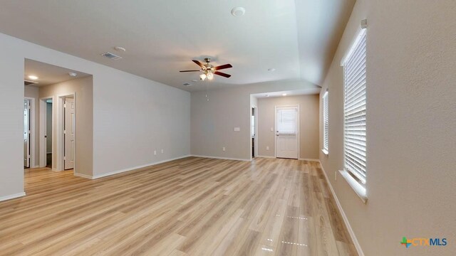 unfurnished living room featuring ceiling fan and light hardwood / wood-style floors