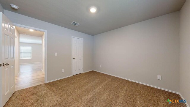 unfurnished bedroom featuring carpet