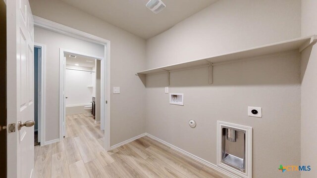 laundry room featuring hookup for an electric dryer, light hardwood / wood-style floors, gas dryer hookup, and hookup for a washing machine