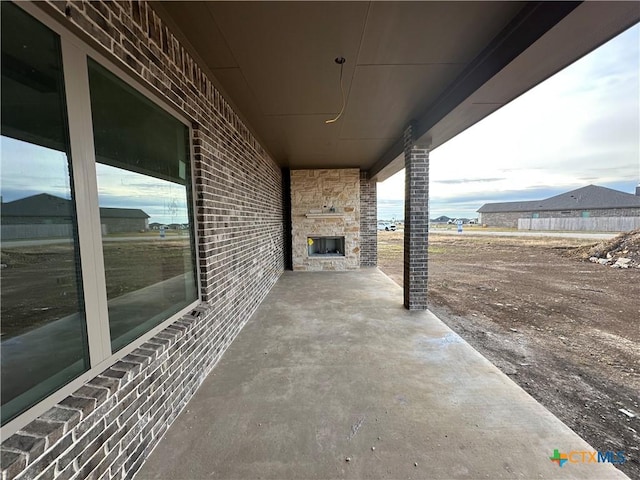 view of patio with an outdoor stone fireplace