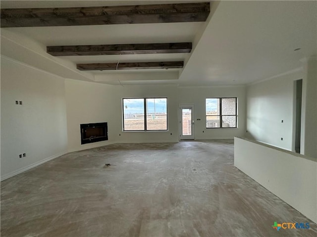 unfurnished living room with concrete flooring and beamed ceiling