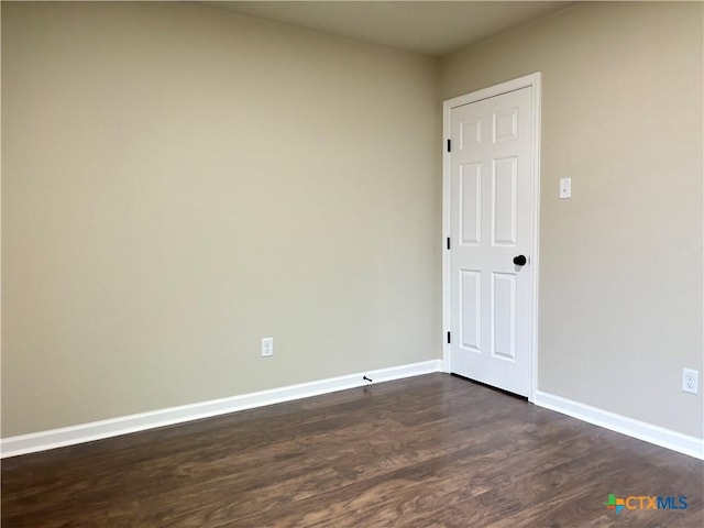 spare room featuring dark hardwood / wood-style floors