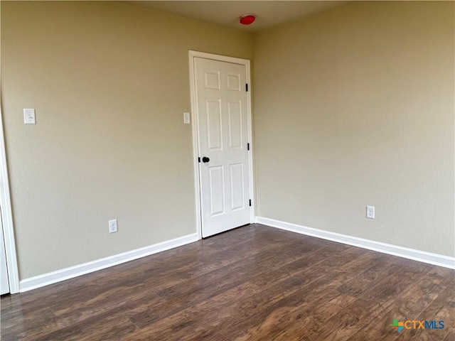 empty room featuring dark hardwood / wood-style flooring