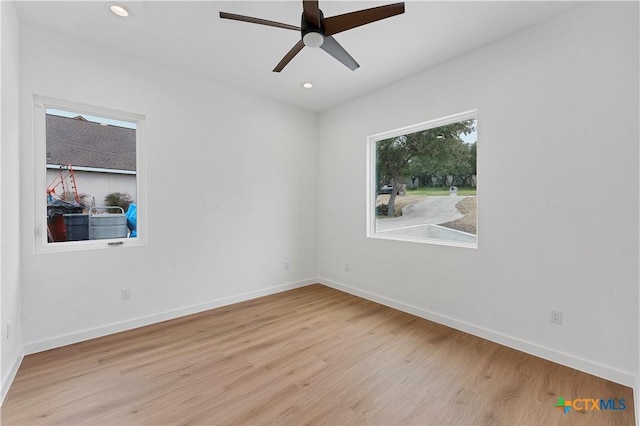 unfurnished room with light hardwood / wood-style flooring and ceiling fan