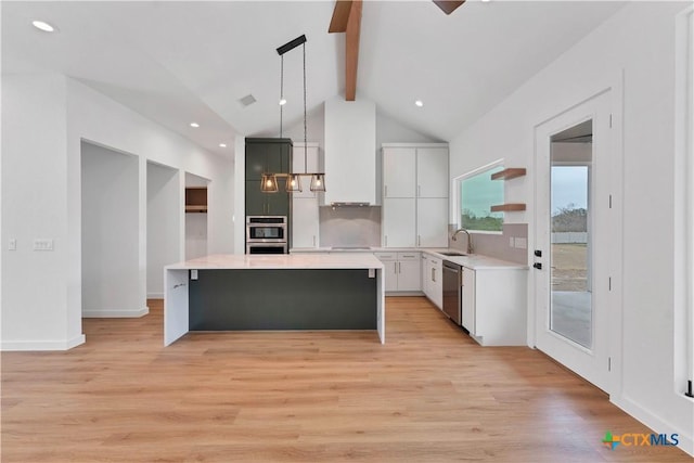 kitchen featuring pendant lighting, premium range hood, stainless steel appliances, a center island, and white cabinets