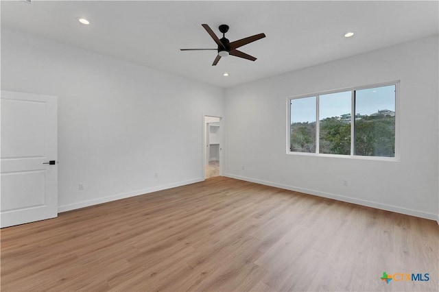 spare room with ceiling fan and light hardwood / wood-style flooring