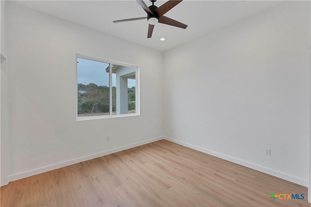 empty room featuring ceiling fan and light wood-type flooring