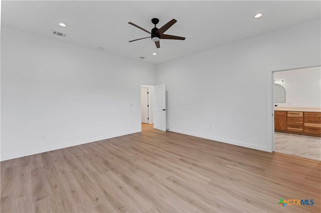 unfurnished bedroom with light hardwood / wood-style flooring, ceiling fan, and ensuite bathroom