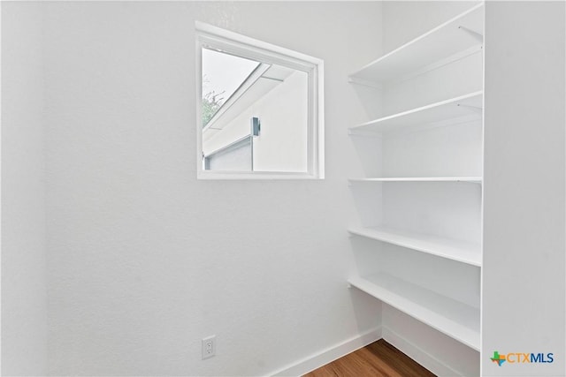 spacious closet featuring hardwood / wood-style floors