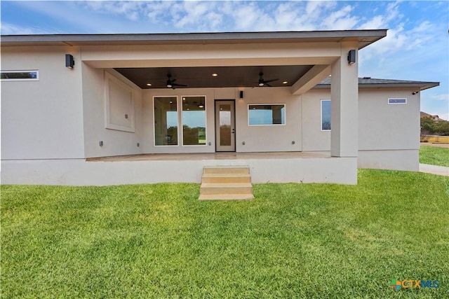 back of property featuring a patio, ceiling fan, and a lawn