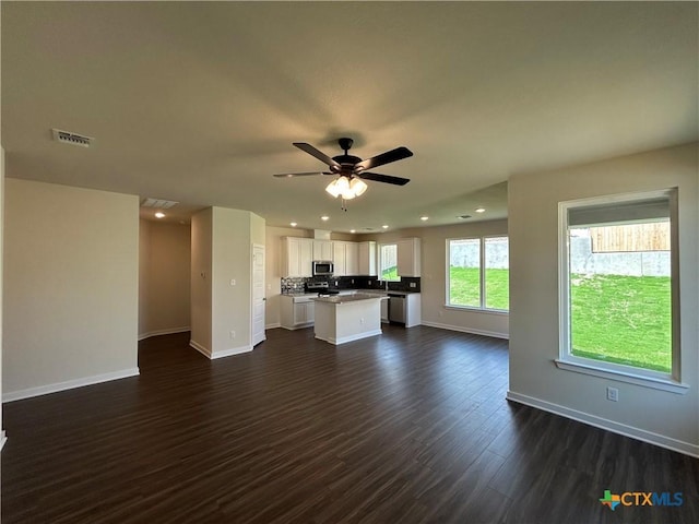 250 Wind Ridge Dr, Copperas Cove, TX 76522 - unfurnished living room featuring baseboards, recessed lighting, a ceiling fan, dark wood-type flooring, and visible vents