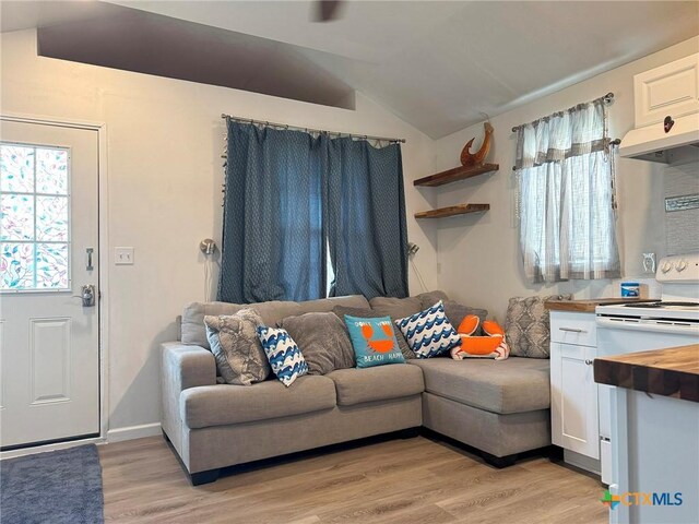 1008 W Dallas Ave, Seadrift, TX 77983 - living room featuring a wealth of natural light, light wood-type flooring, and vaulted ceiling