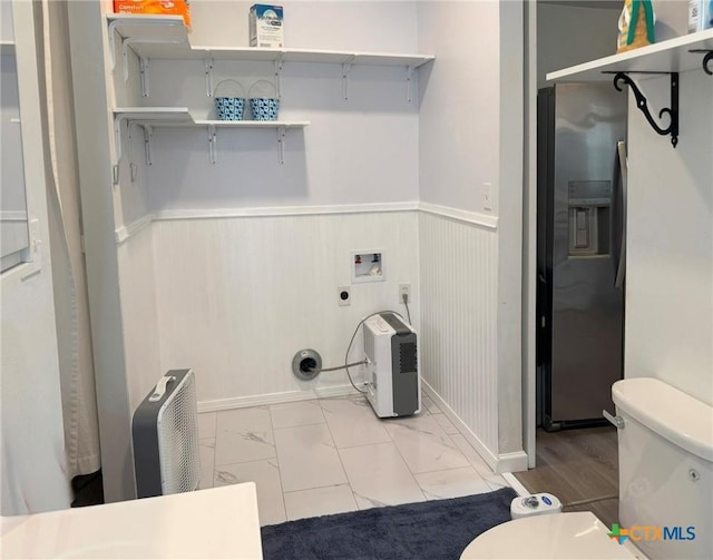 1008 W Dallas Ave, Seadrift, TX 77983 - laundry area featuring hookup for a washing machine, laundry area, a wainscoted wall, and electric dryer hookup